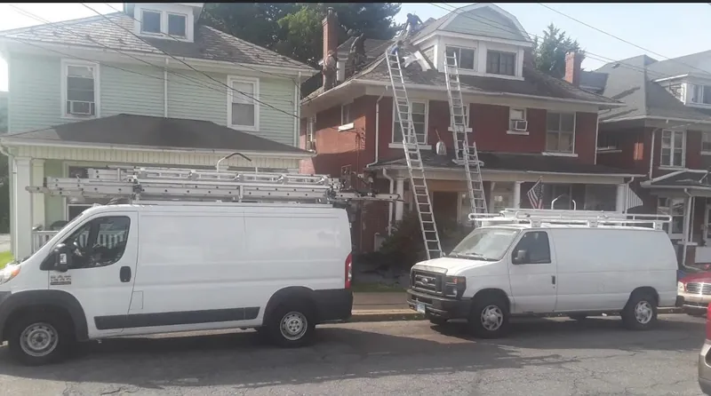 EMA vans on a roofing job
