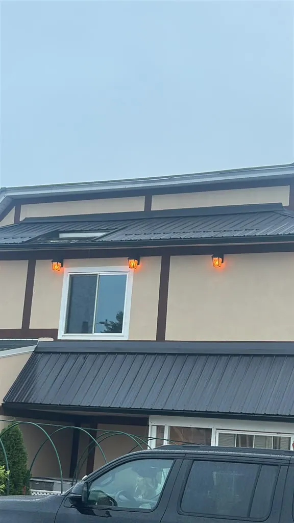 Metal roof awnings on a stucco building