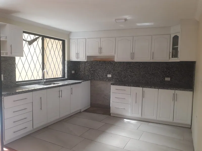 White kitchen cabinets with granite counters
